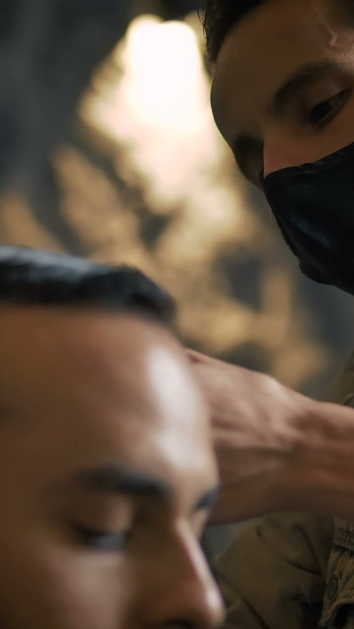 Barber working closely on a client's haircut