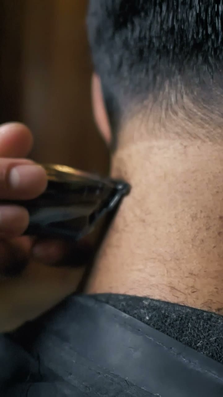 Barber trimming the back of a client's neck